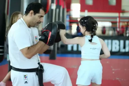 martial A girl training in martial arts with her coach